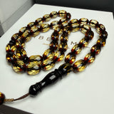 مصباحة من الكهرمان الأسود والماس، مقاس 8.5 × 12.5 مم، وزن 29.9 غرام، مع سوار هدية.