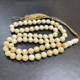 مسبحة من الكهرمان الأبيض مصنوعة يدوياً | 10.8 مم | 48 غ | 66 حبة