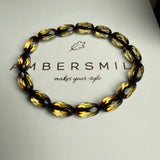 مصباحة من الكهرمان الأسود والماس، مقاس 8.5 × 12.5 مم، وزن 29.9 غرام، مع سوار هدية.